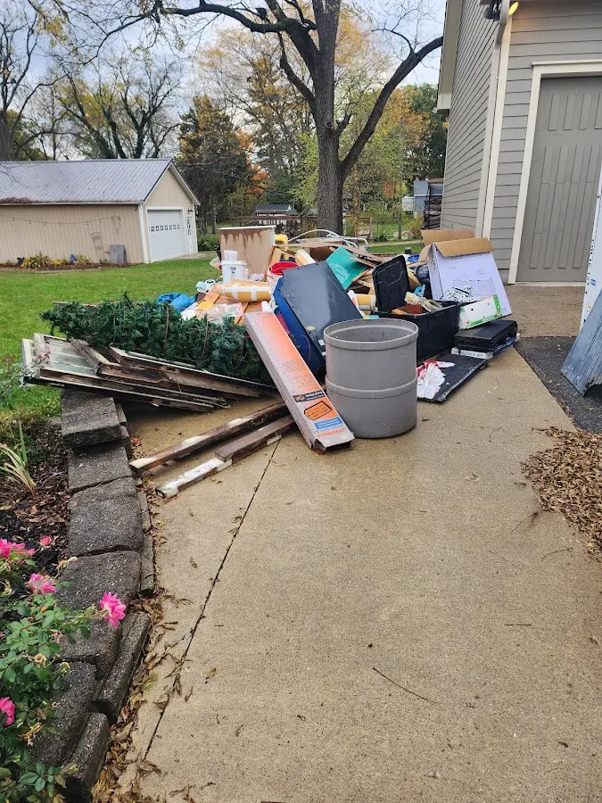 Dumpster being loaded with debris for Estate Cleanout Dumpster Rental in Rumford
